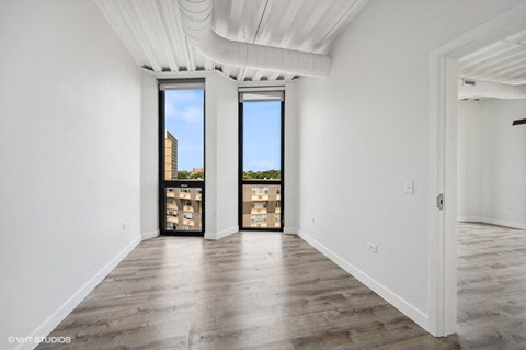 a living room with white walls and a large window