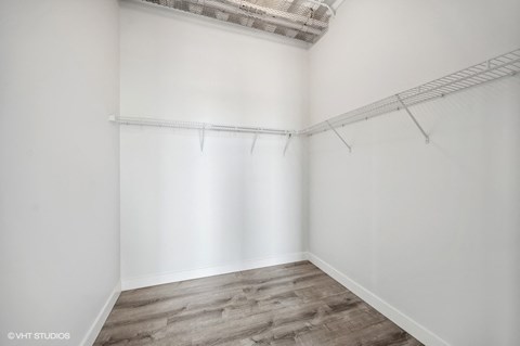 an empty room with white walls and a wood floor
