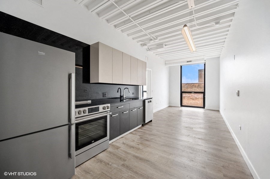 a kitchen with stainless steel appliances and white cabinets