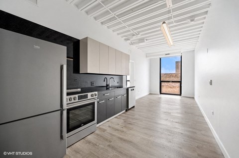 a kitchen with stainless steel appliances and white cabinets
