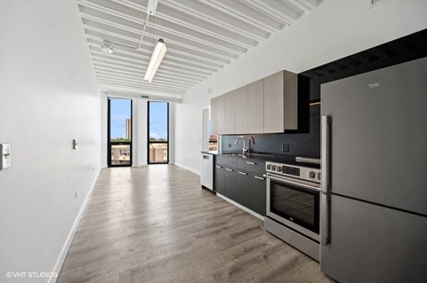 a kitchen with stainless steel appliances and black and white cabinets
