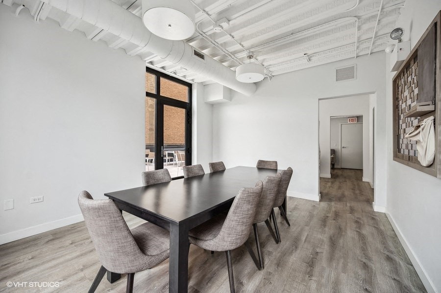 a dining room with a long table and chairs