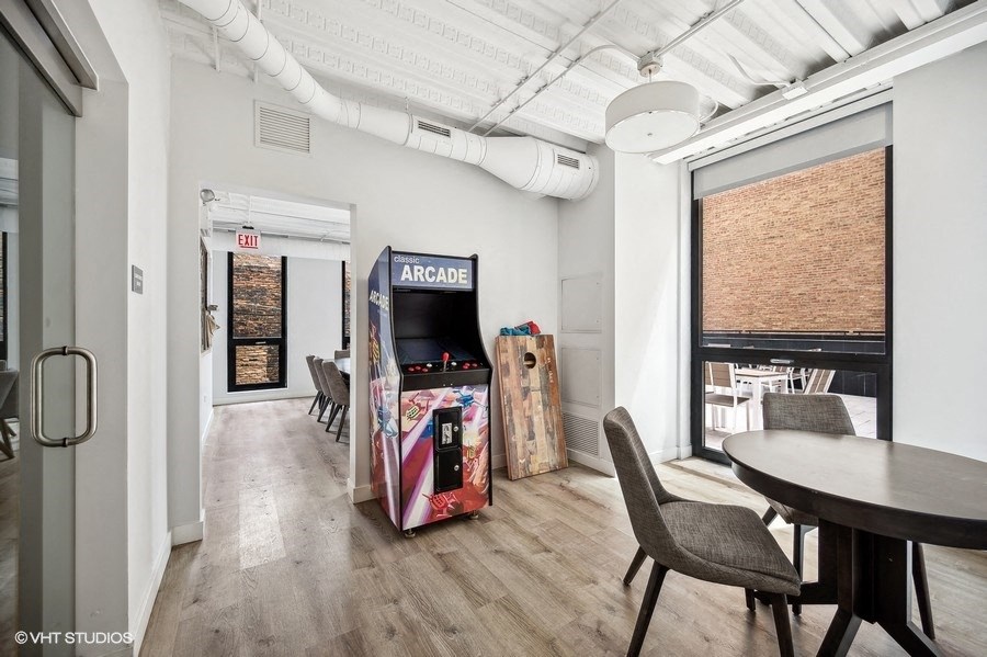 a dining room with a table and chairs and a vending machine