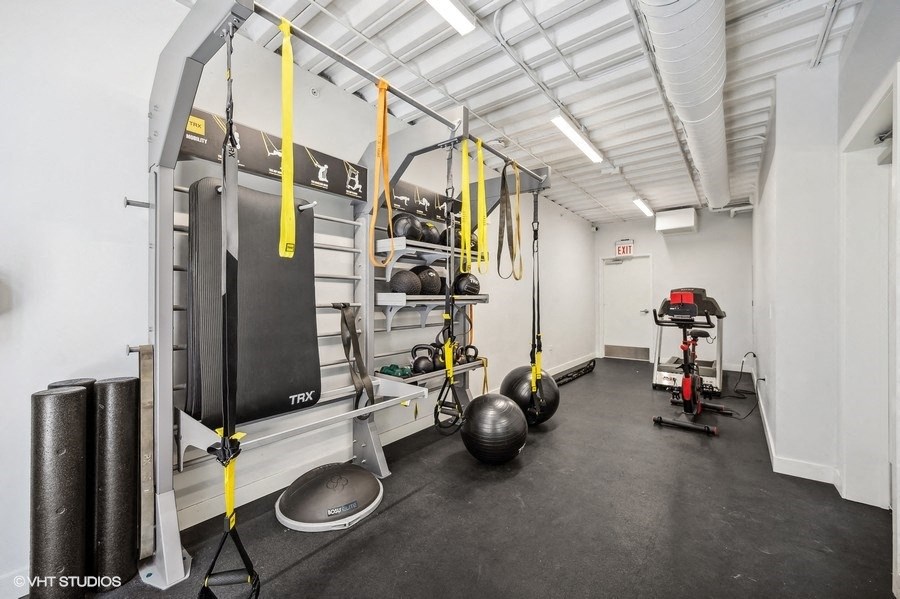 a workout room with weights and other equipment in a building