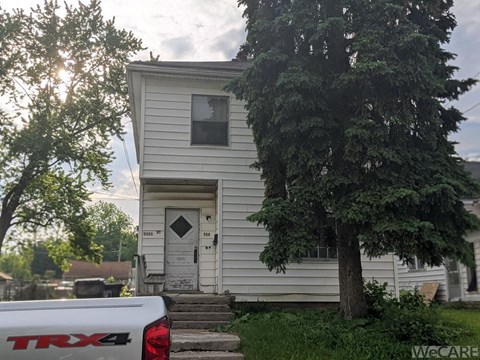 a white house with a truck parked in front of it