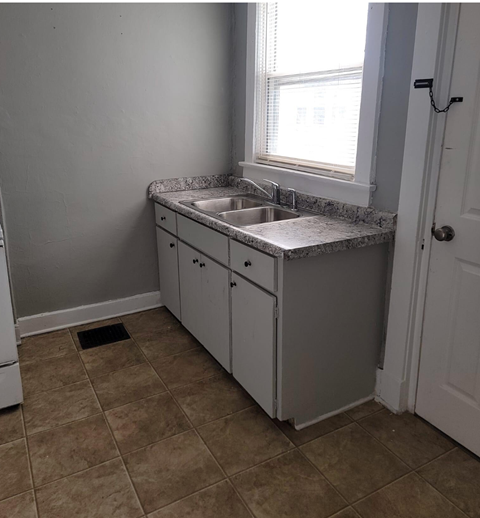 a small kitchen with a sink and a window