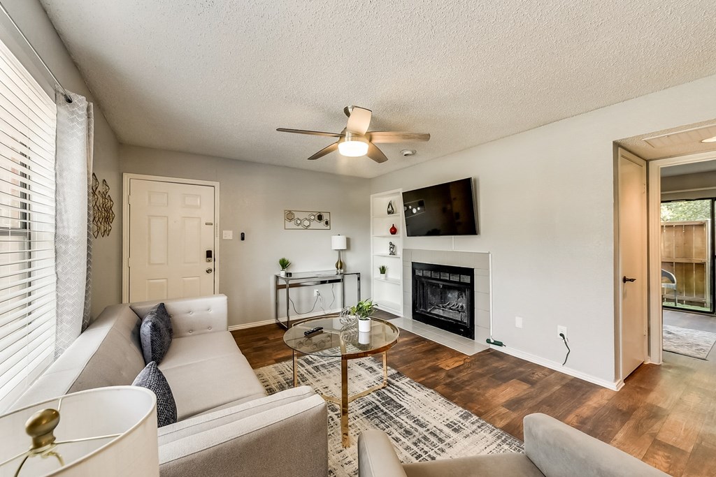 a living room with a couch and a table and a fireplace