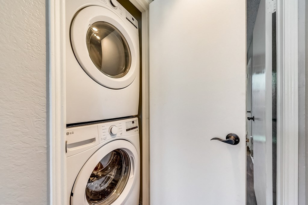 a front loading washer and dryer in a laundry room