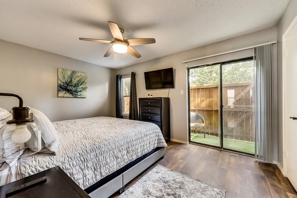 the master bedroom has a large sliding glass door to the patio