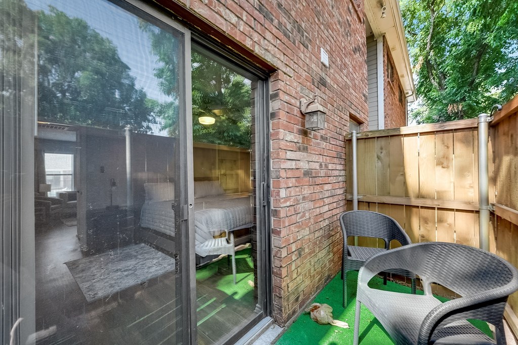 a backyard with patio furniture and sliding glass doors