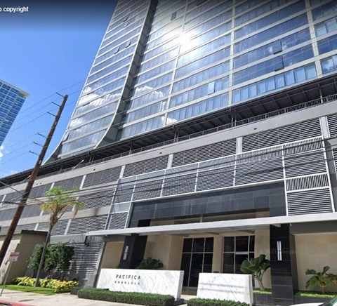 A modern building with a sign that reads "PACIFICA" in front of it.