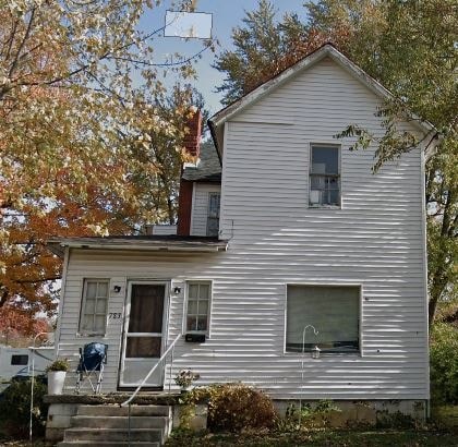 a white house with a yard in front of it