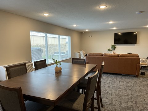 a dining room with a table and chairs and a couch