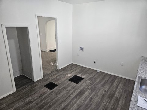 A room with a sink and a doorway leading to another room.