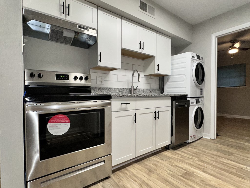 a kitchen with stainless steel appliances and white cabinets