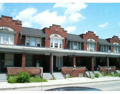 a red brick building with a street in front of it