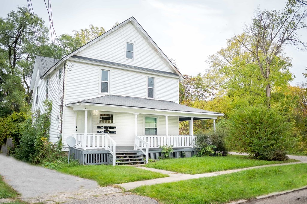 a white house with a porch and a white