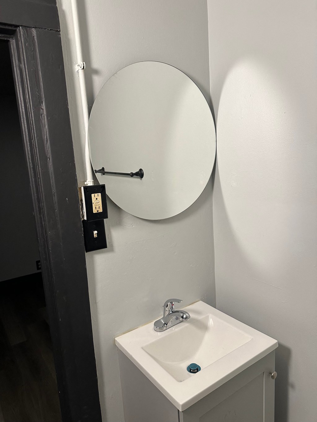a small bathroom with a sink and a mirror