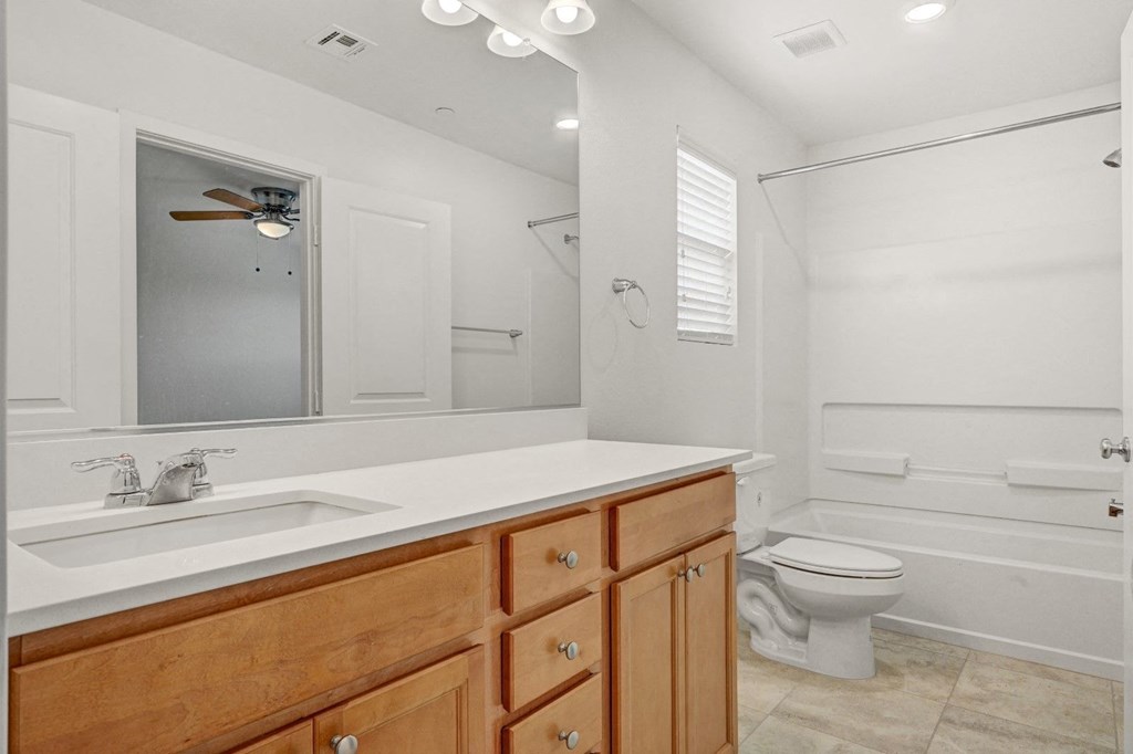 a bathroom with a sink toilet and a mirror