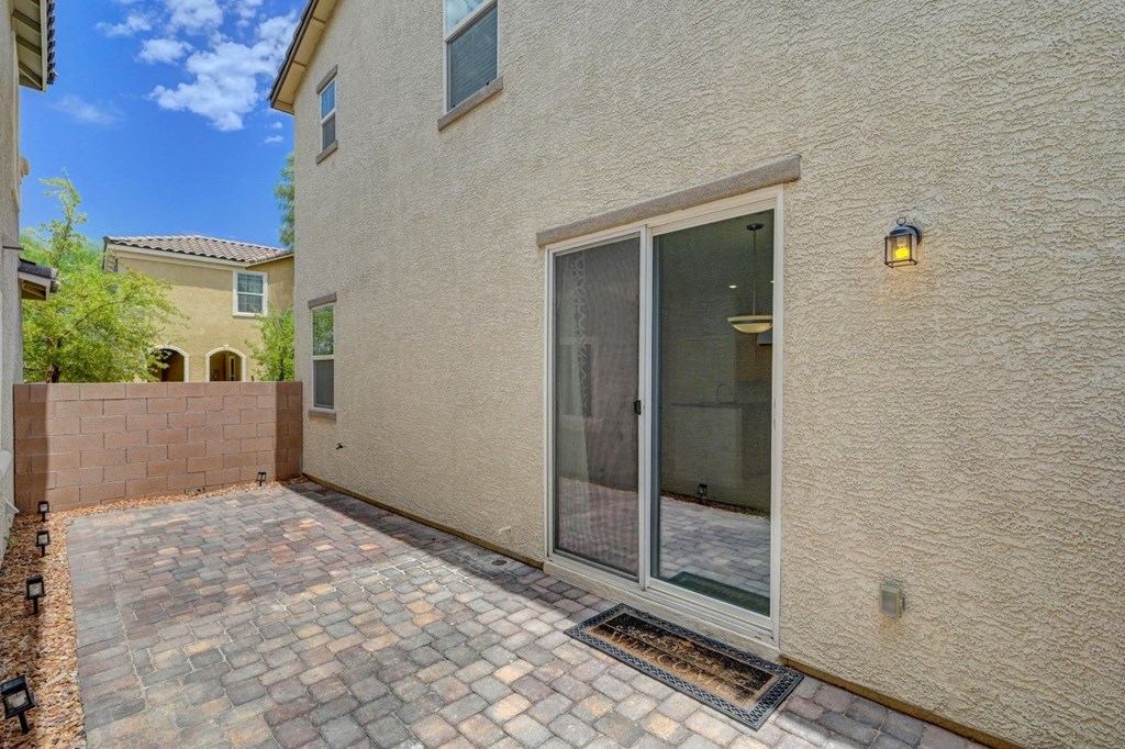 a brick house with a patio and a glass door