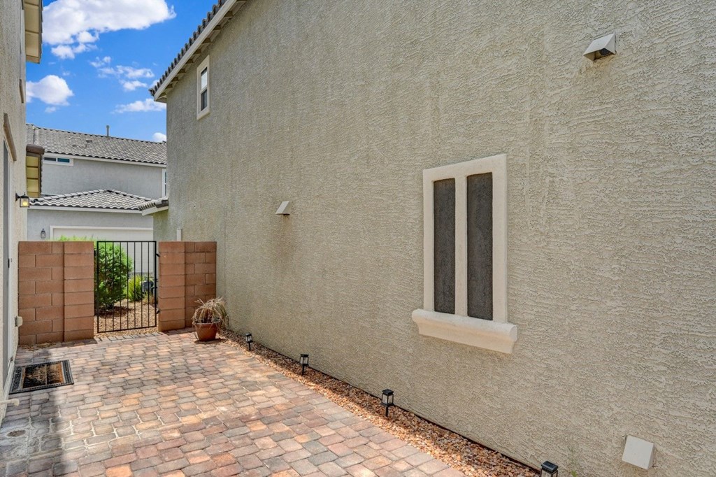 the side of a house with a driveway and a window