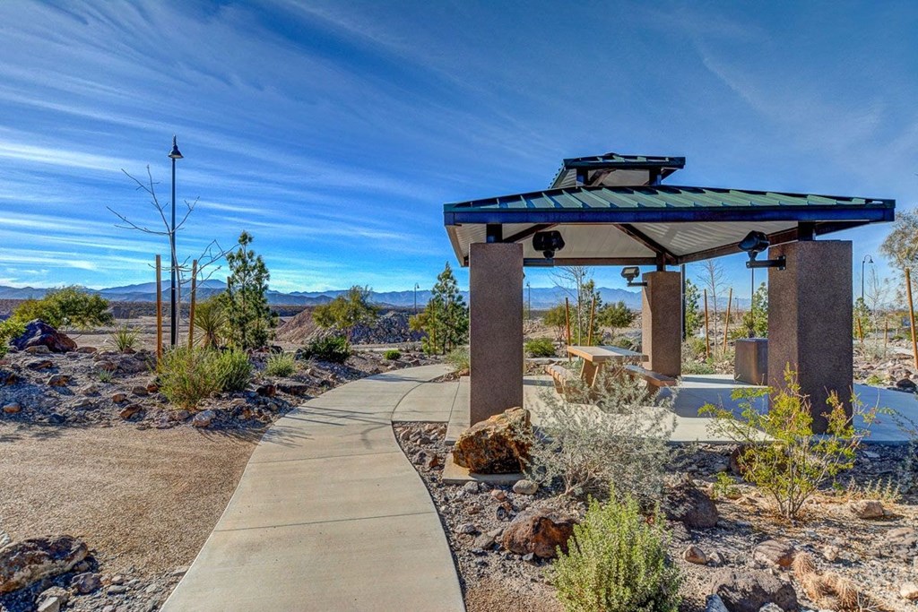 a gazebo with a sidewalk in the desert