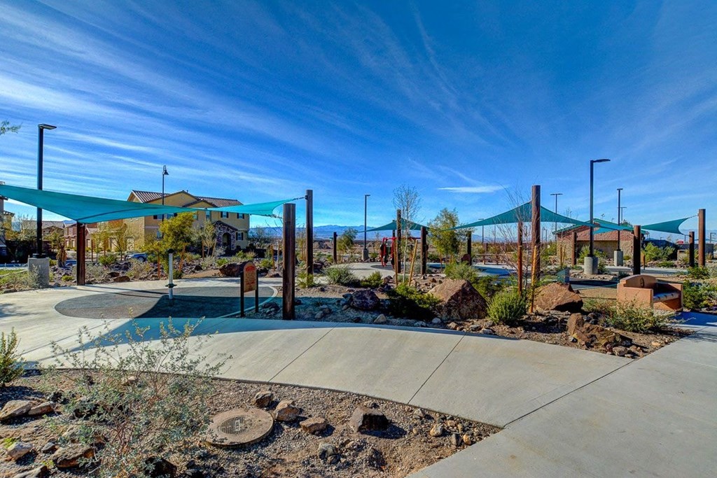 a view of a park with a playground and buildings