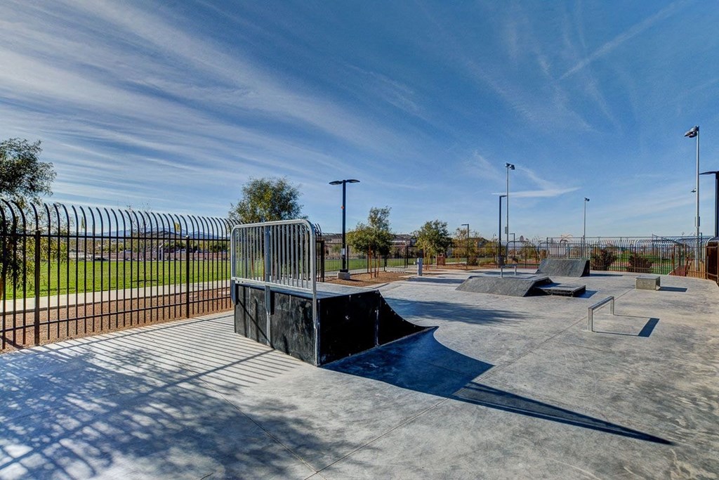 a skate park with skate ramps and a fence