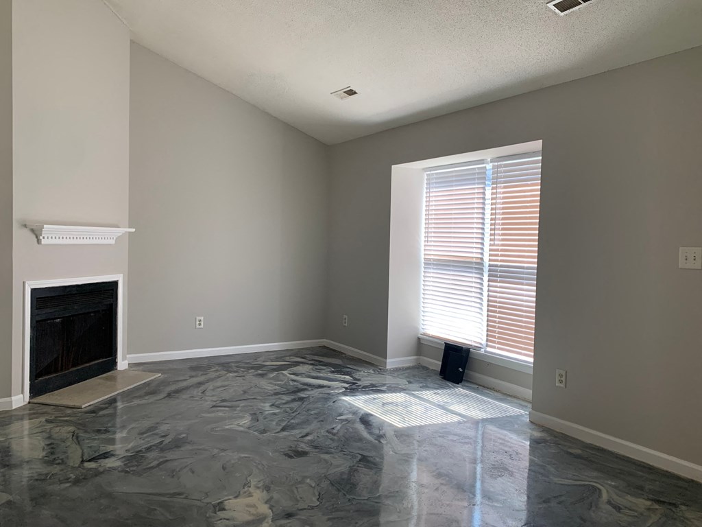a living room with a fireplace and a window
