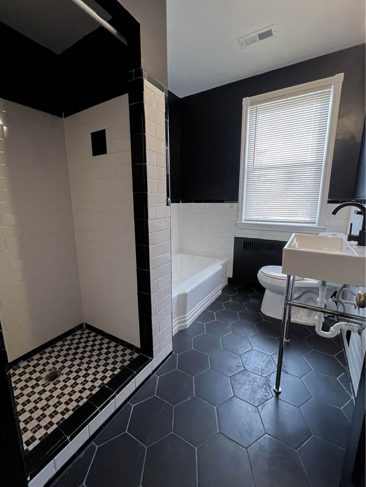 a black and white bathroom with a toilet and a sink