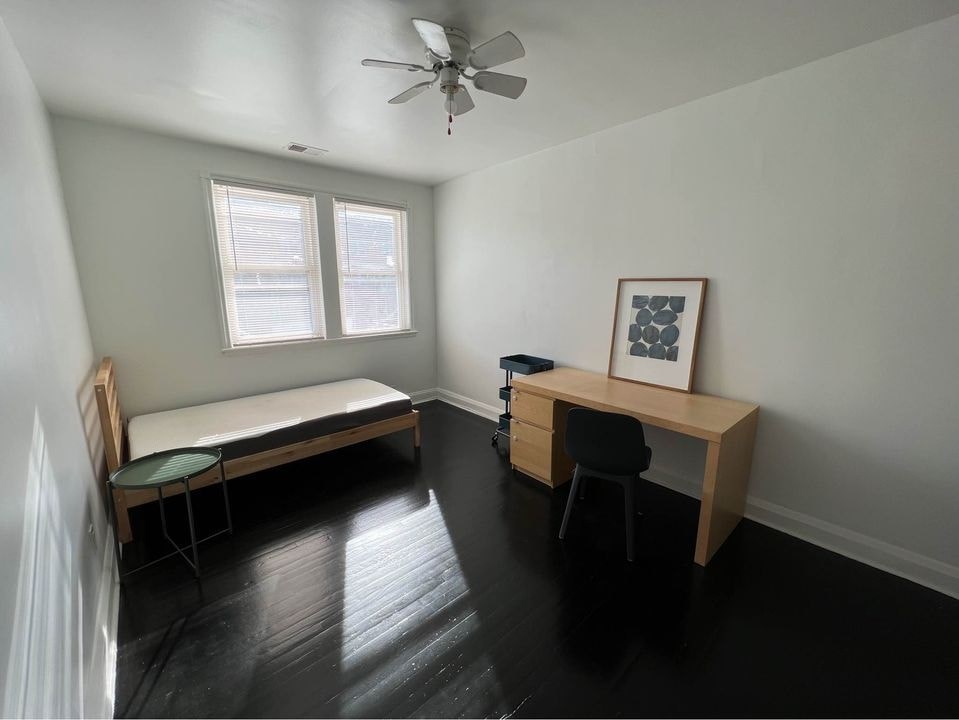 a small room with a desk and a couch