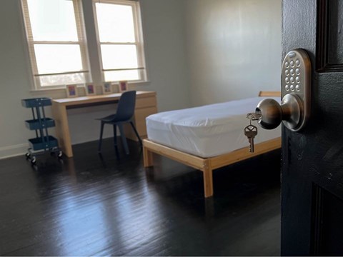 a bedroom with a bed and a key in the door
