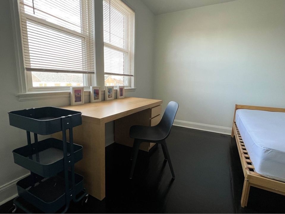 a small room with a desk and a bed