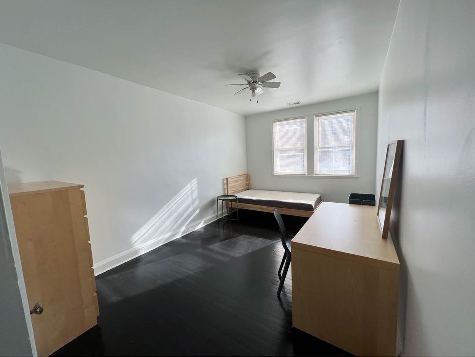 an empty room with a desk and a bed in it