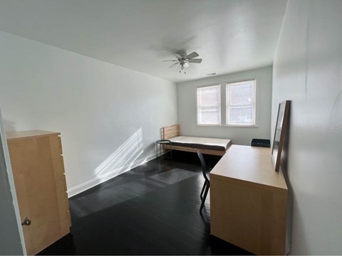 an empty room with a desk and a bed in it