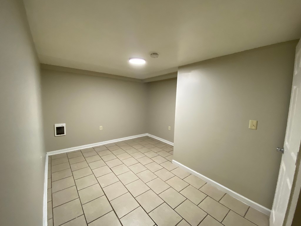 A room with a tiled floor and a light on.