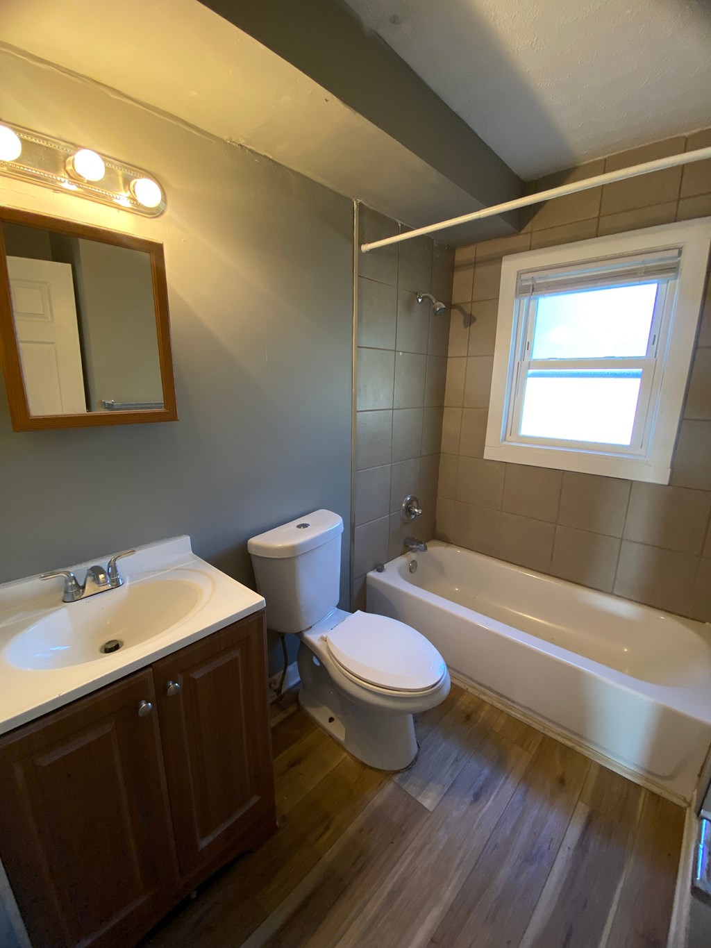 A white toilet sits next to a sink in a bathroom.