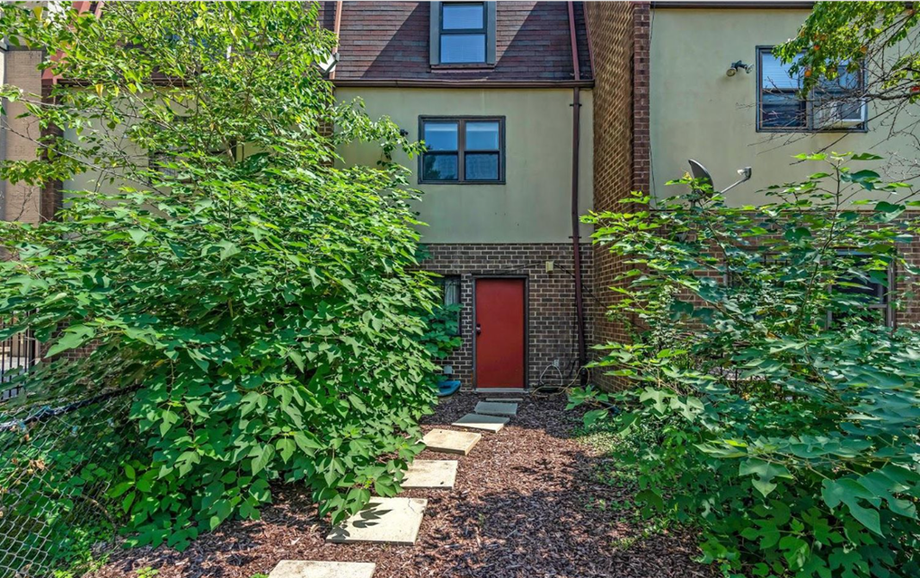 the front of a house with a red door