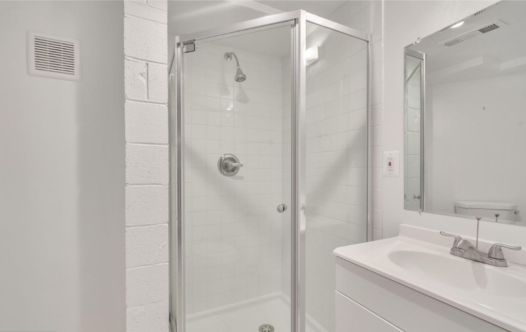a bathroom with a shower and a sink