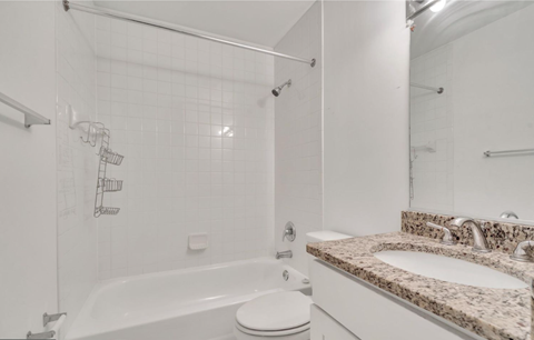 a bathroom with a tub and a sink and a toilet