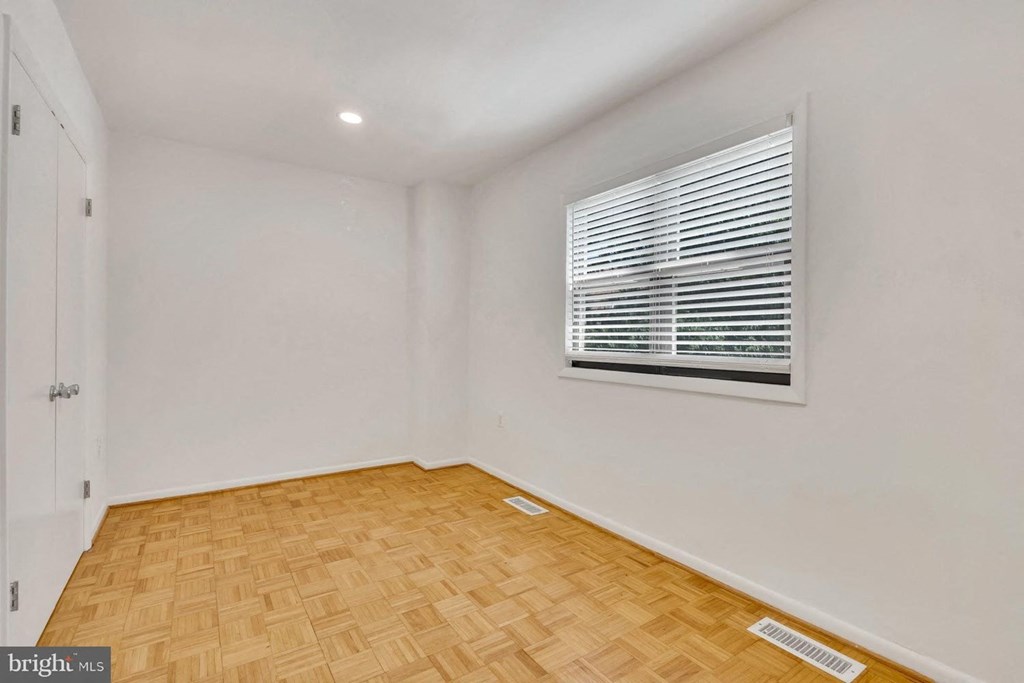 a living room with a window and wooden floors