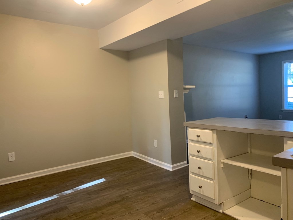 an empty room with a desk and a window