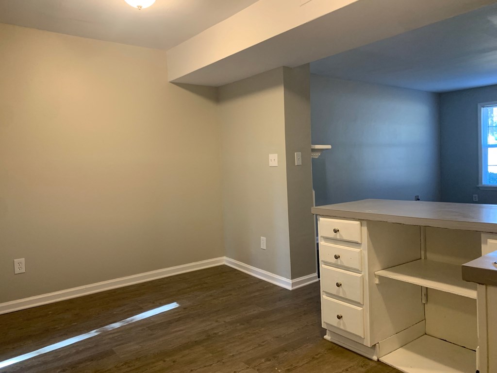 an empty room with a desk and a window