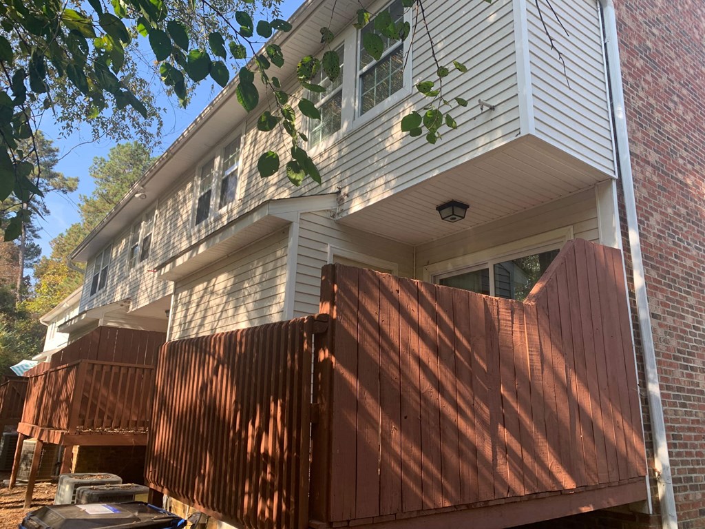 a house with a wooden fence in front of it