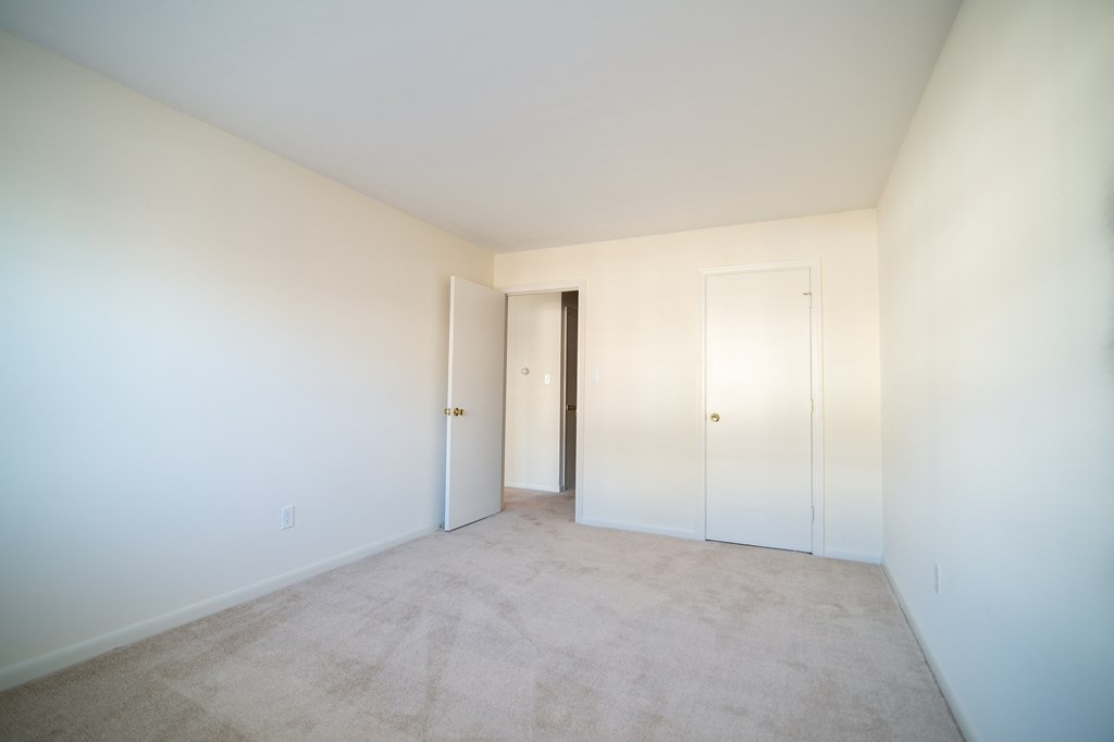 an empty room with white walls and doors