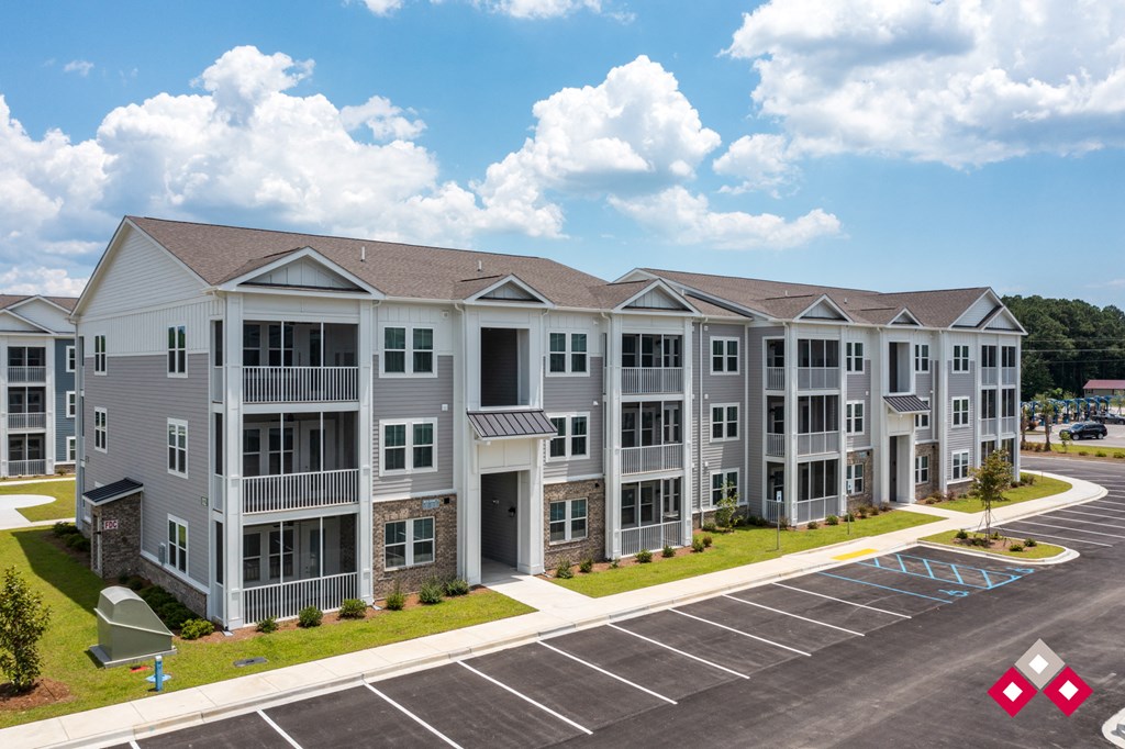 an image of an apartment building in a parking lot