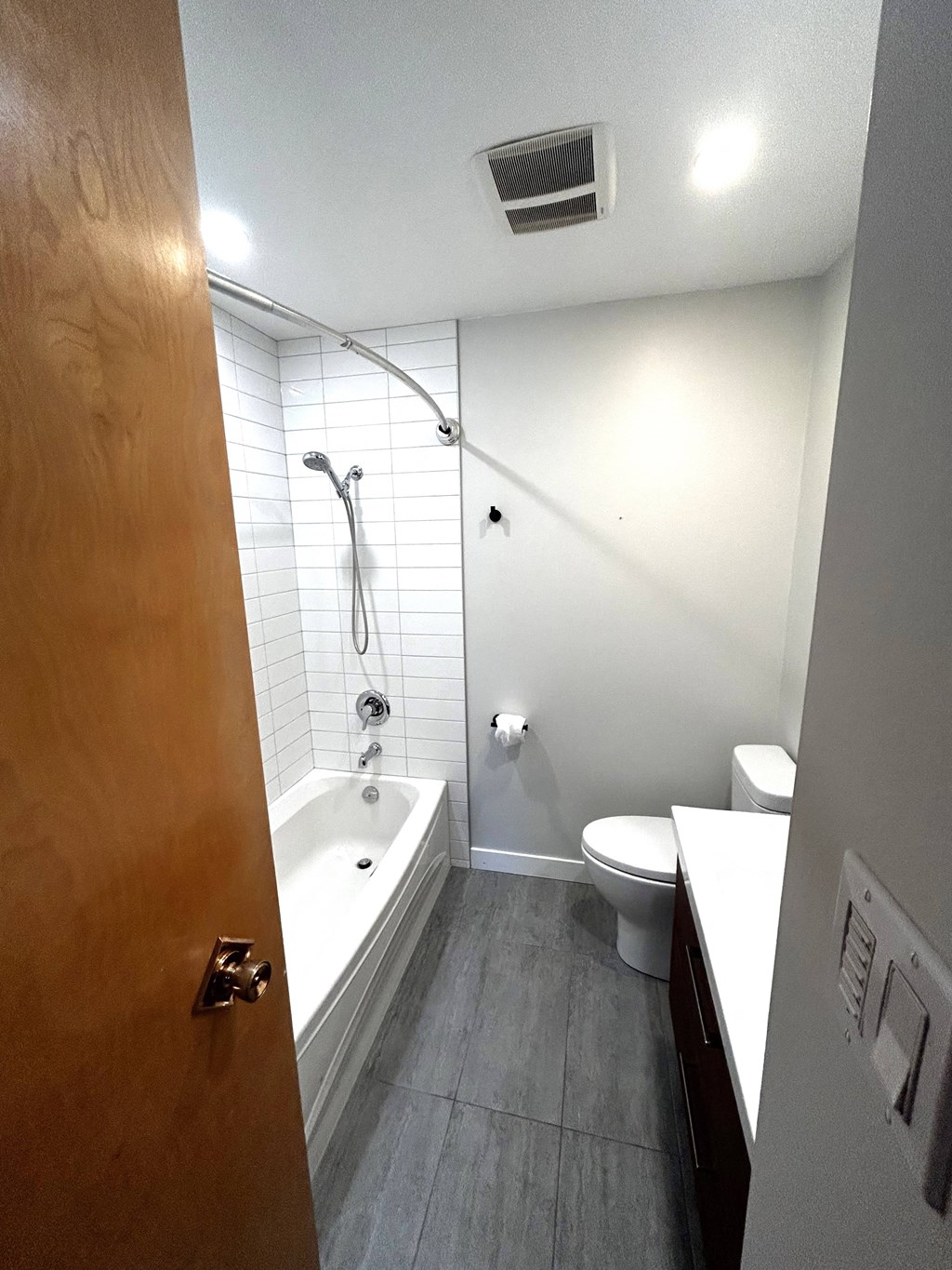 a small bathroom with a shower toilet and sink