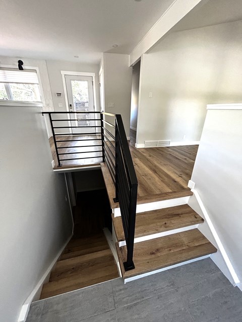 a view of the stairwell from the bottom of the house looking up the stairs
