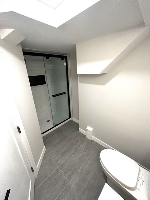 a small bathroom with a toilet and a shower