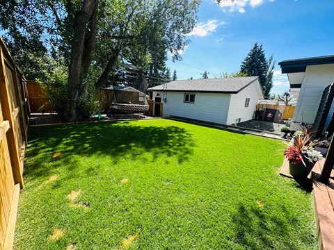 a backyard with a house and a yard with grass